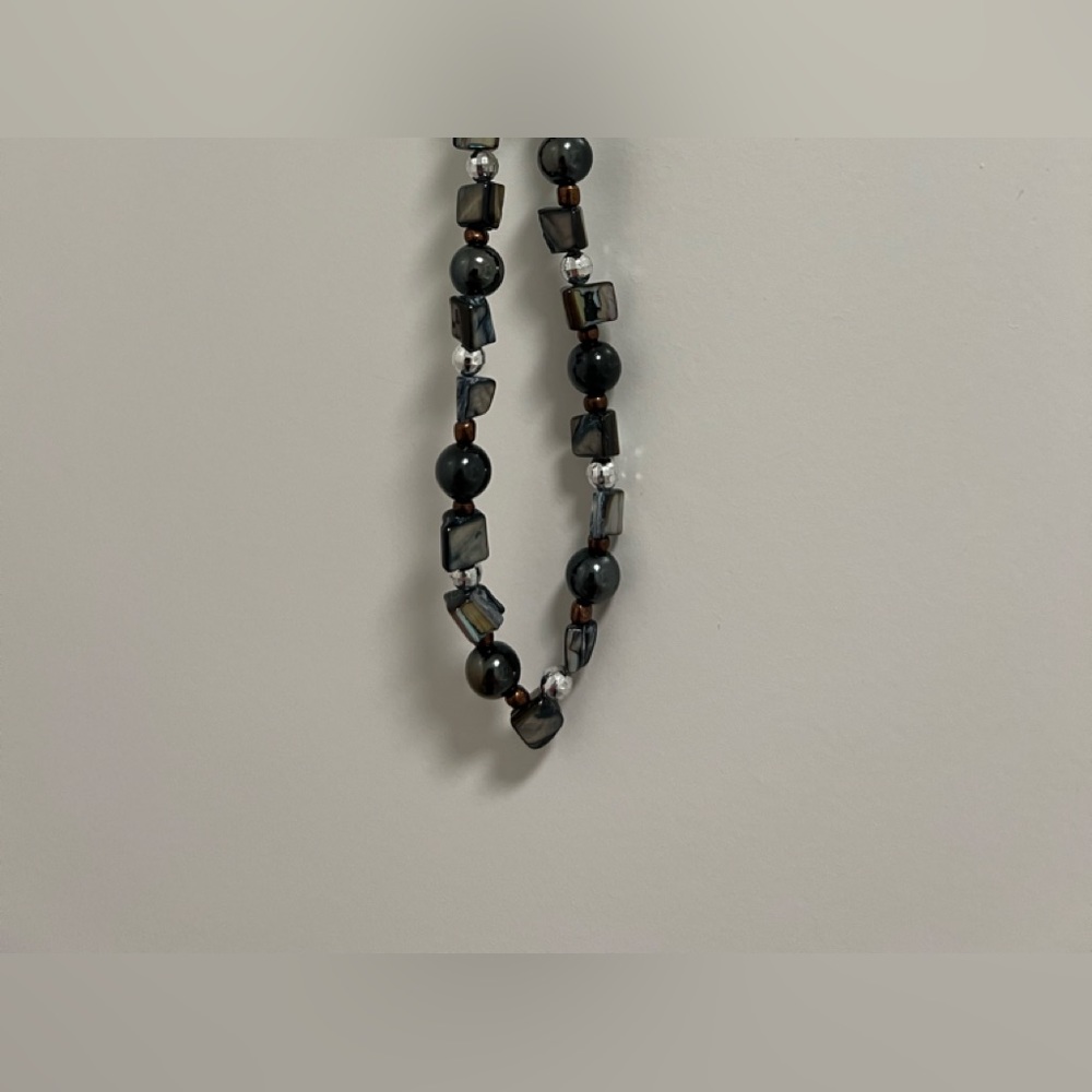 Predominantly black, with silver, brown beads.